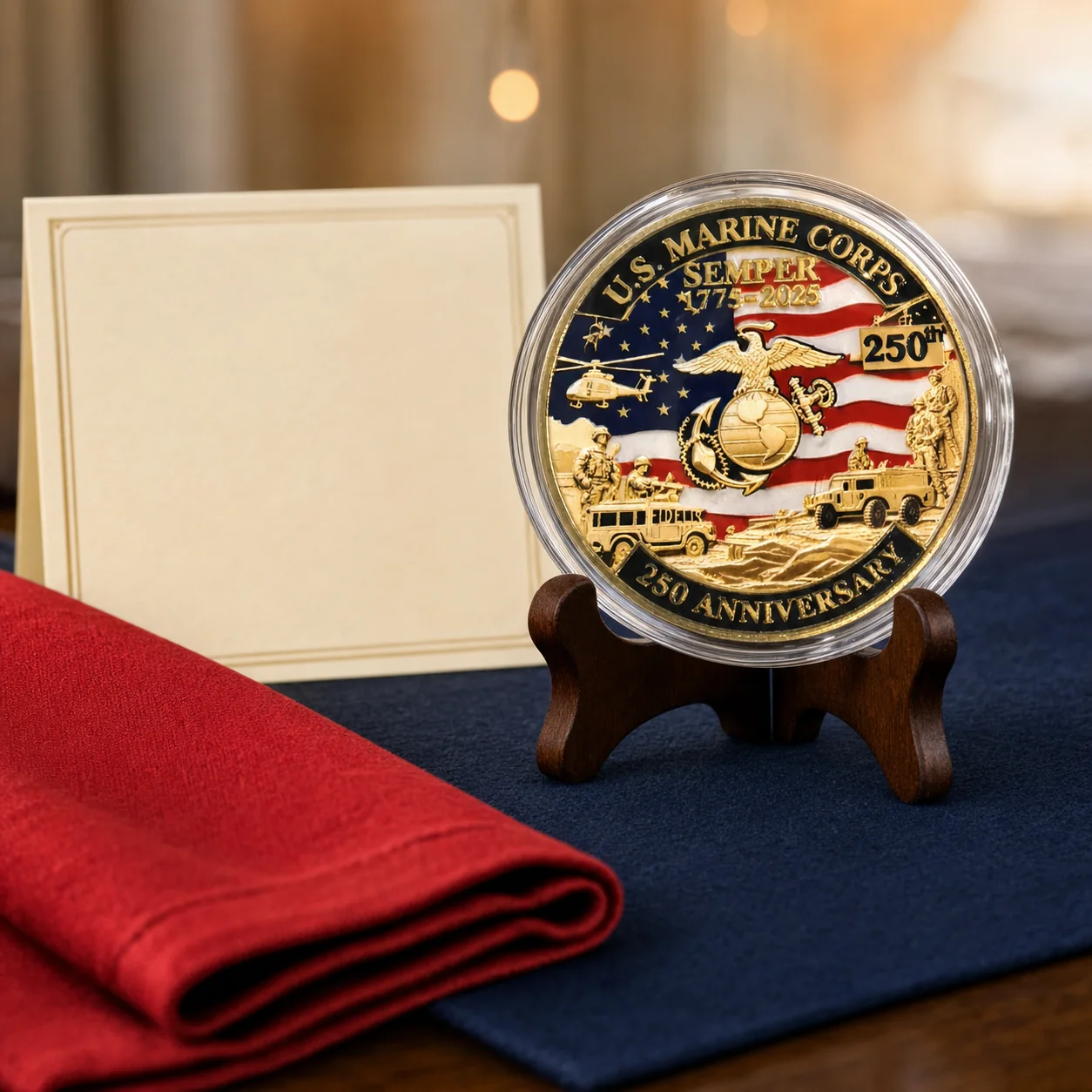 Marine Corps 250th anniversary coin in its clear case on a walnut stand at a red and navy birthday table