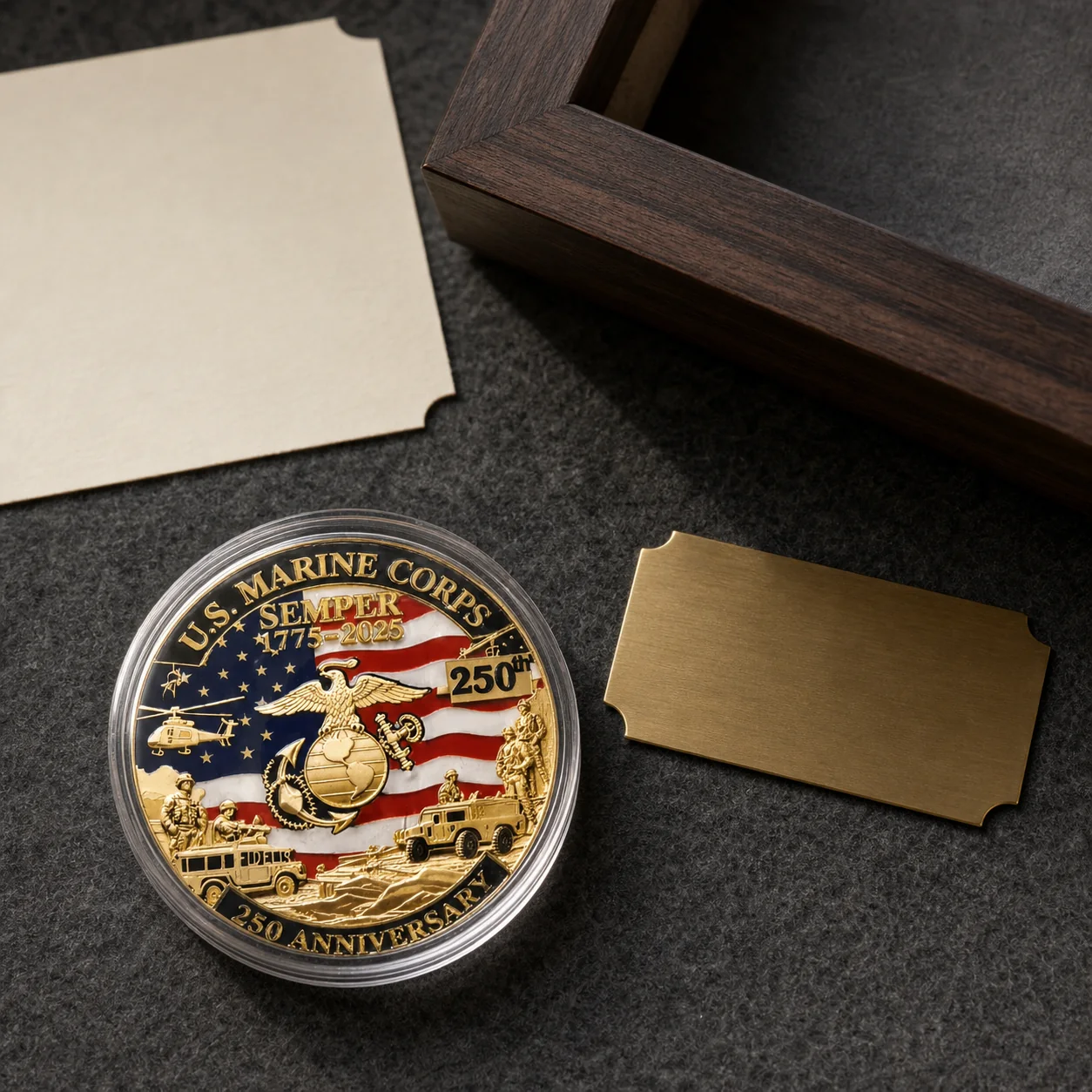 Cased Marine Corps 250th anniversary coin beside a blank brass nameplate and dark wood shadowbox frame